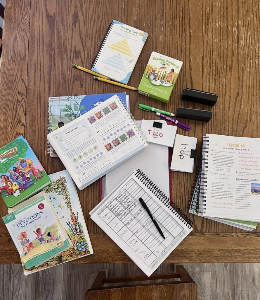 A simple homeschool setup on a table ready for the day's lessons, showing a calm and intentional learning environment at home.