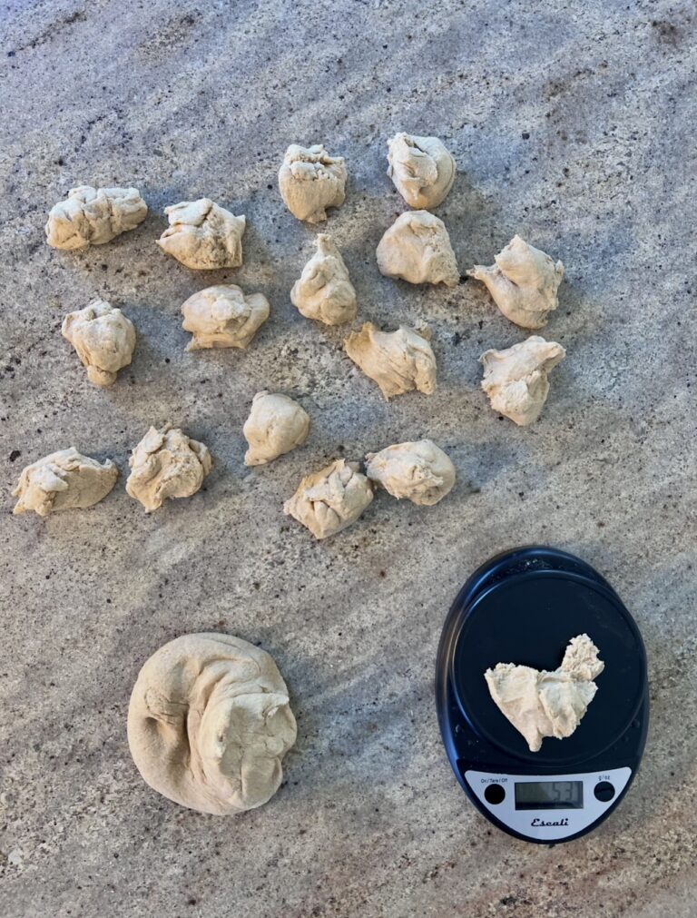 Dough balls being weighed and portioned on a kitchen scale as part of a weekly meal rhythm and homemade cooking routine for a busy family.