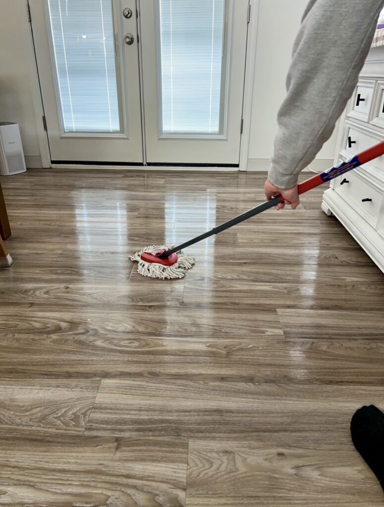mopping floors as part of simple daily cleaning routine for busy homemaker