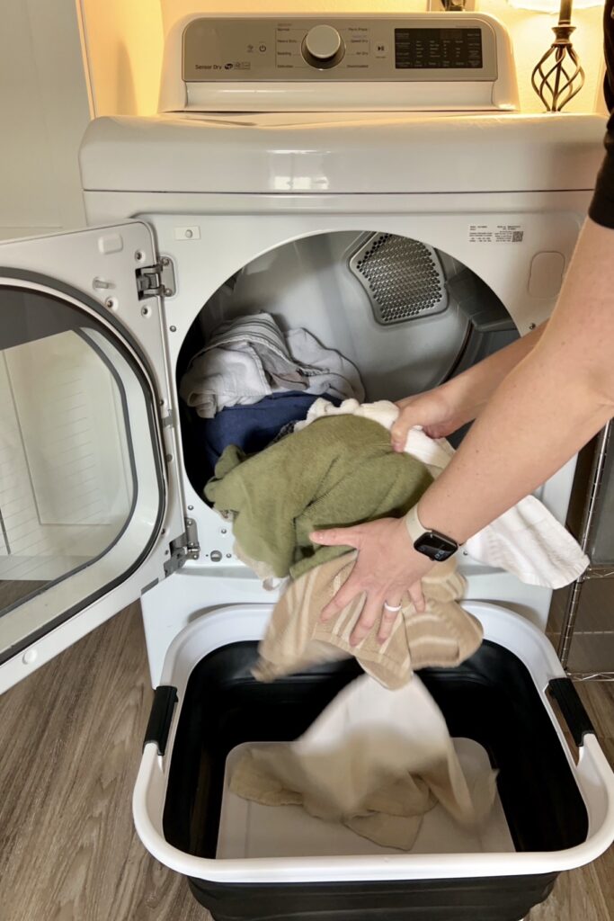 Overwhelmed by laundry piles pulling clothes from dryer real life stay at home mom laundry routine